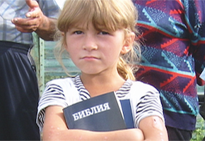 girl with bible 290x200