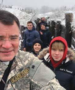On the shore of the Sea of Azov. This freshly dug trench is only one hundred meters (100 yds) from Gennady’s home. Some of Gennady’s 33 children in the photo. Some of the children are too young to understand the purpose of the trenches.