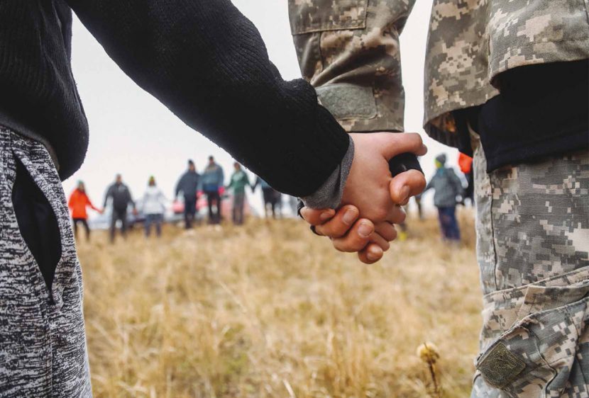 Feb19Web5 An outdoor prayer meeting on the outskirts of the city of Mariupol. With Russian weaponry just 15 miles away, believers hold hands and pray ”Lord, protect our city...”