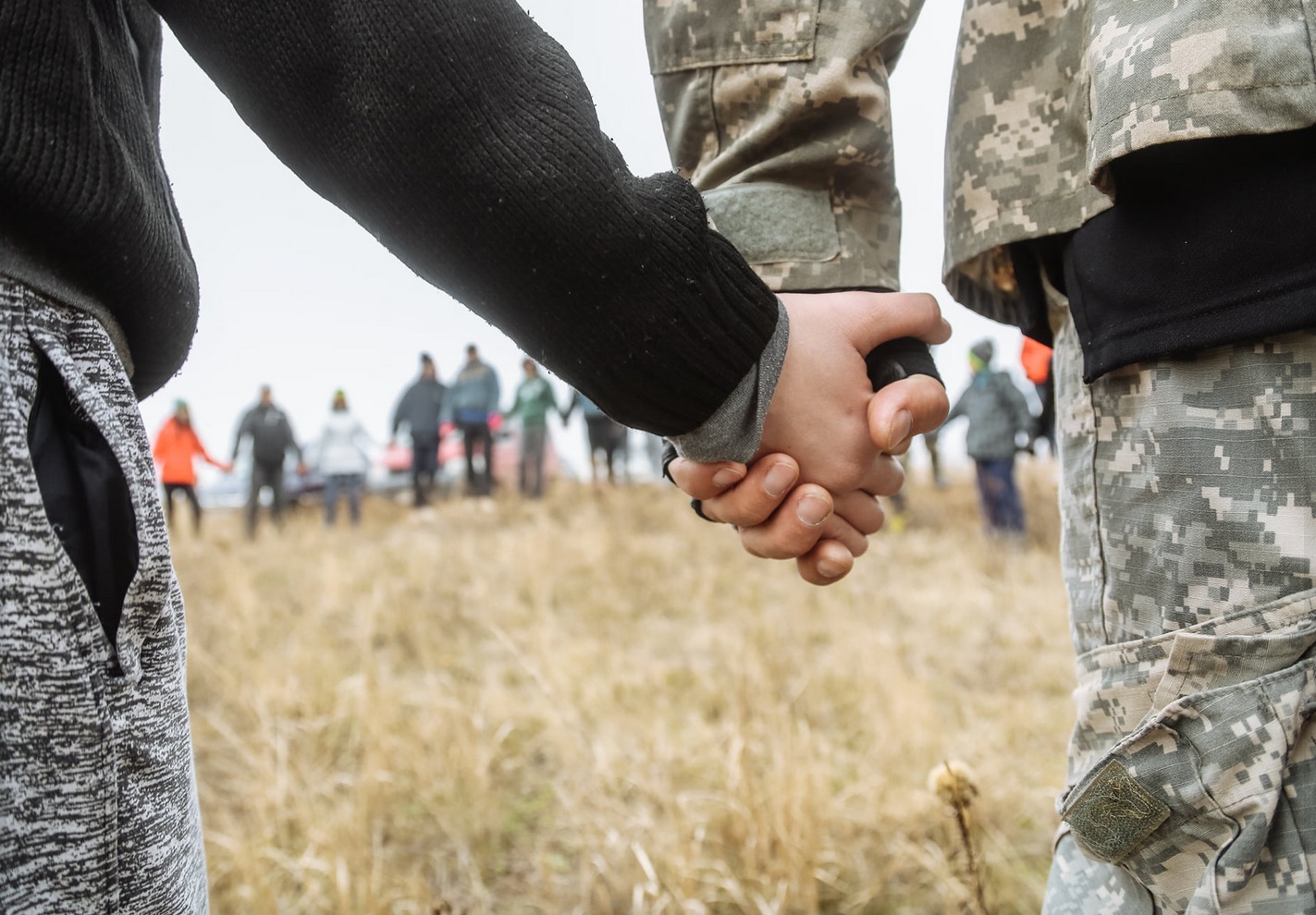Ukraine-soldier-child-handinhand A moment of prayer among villagers, soldiers and children.
