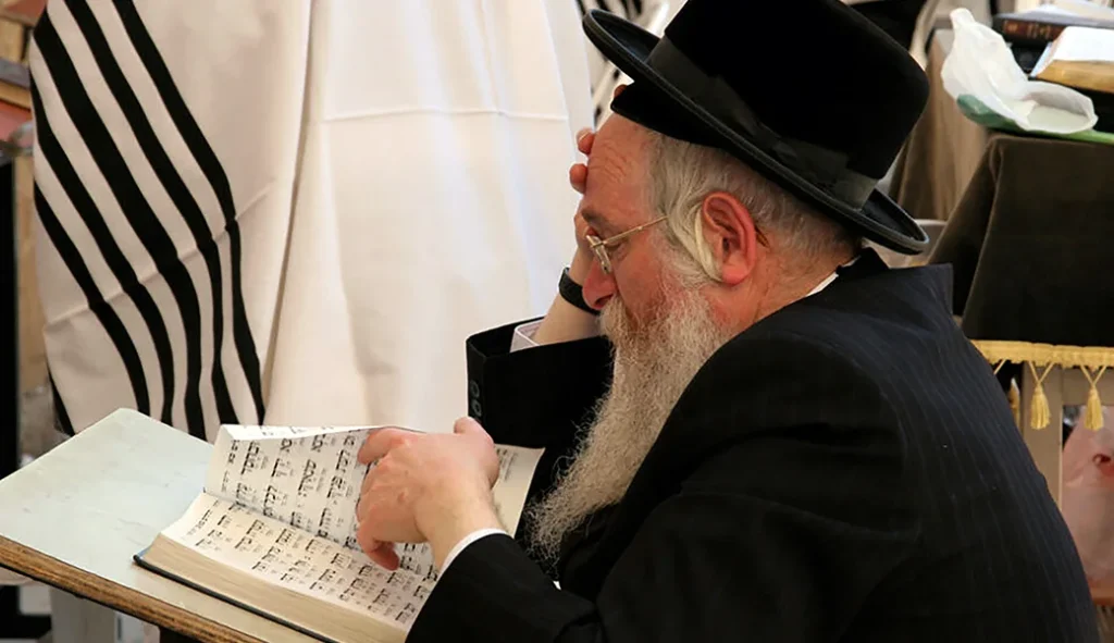 A Jewish man reads from a Hebrew prayer book, representing the people GCMM hopes to reach with Gospel resources in Israel.