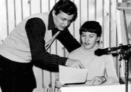 Hannu and Laura Haukka reviewing a script together at an early home radio studio microphone