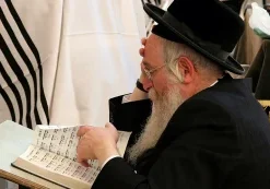 A Jewish man reads from a Hebrew prayer book, representing the people GCMM hopes to reach with Gospel resources in Israel.